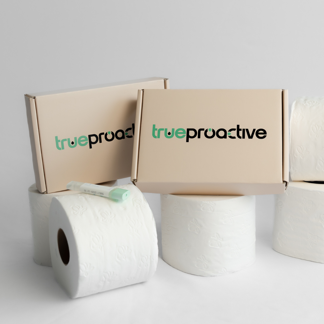 Two True Proactive bowel cancer screening FIT Test boxes with 'true proactive' branding and toilet paper rolls on a light gray background.